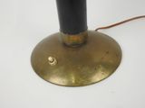 a black lamp that is on top of a table