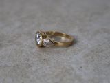 a close up of a gold ring with a diamond on it