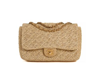 a chanel beige straw bag with gold hardware and chain