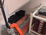 a hand truck that is sitting in the corner of a room