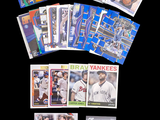 a lot of baseball cards that are on the table