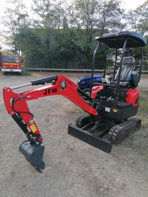 a small excavator that is parked on the side of the road