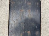 a metal plate that has holes in it on the ground