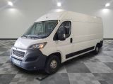 the white van is parked on a checkered floor in the garage