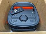 a box with a remote and a speaker inside of it