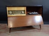 a small wooden cabinet with a radio on it