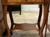 a small wooden table with a drawer on top of it
