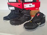 two pairs of black work boots next to each other