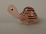 a small toy turtle that is sitting on a table