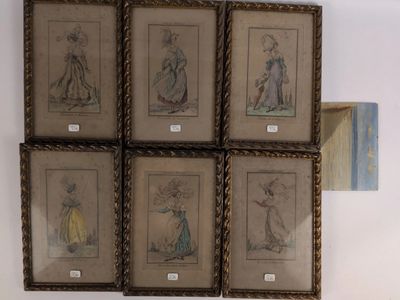 four framed pictures of women in dresses are hanging on a wall