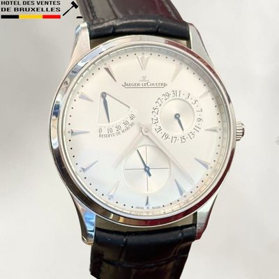 a close up of a wrist watch with a white dial