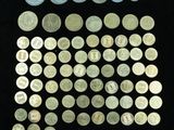 some of the coins are in a display case on a black surface