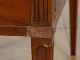 a close up of a wooden table with a drawer on it