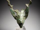 an image of a bronze sculpture of a deer ' s head on a stand