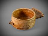 an image of a wooden bowl with a lid on a gray background