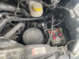 a close up of a car ' s engine with the hood open