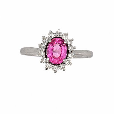 a close up of a pink sapphire and diamond ring on a white background