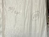 a pile of mattresses and other items in a warehouse