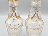 pair of clear glass vases with gold decoration on the sides