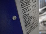 a label on the side of a machine that is sitting on the floor