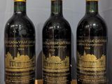 three bottles of wine sitting on top of a wooden table
