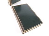 pair of black and gold bookends on a white background