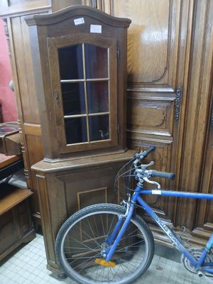 a bike that is parked in front of a cabinet