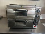 a silver oven sitting on a counter in a kitchen