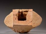 a clay vase with a hole in the middle of it
