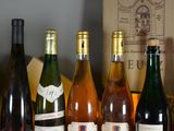 several bottles of wine are lined up on a table