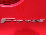 a close up of the emblem on the back of a red car