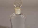 a small glass bottle with a glass stopper on it