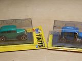 two toy cars that are in a box on a table