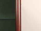 a glass display case with a clock on top of it