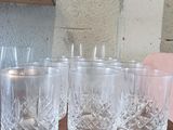 four glasses sitting on a wooden table next to each other