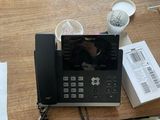 a phone that is sitting on a desk next to a cup of coffee