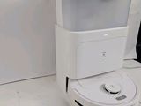 a robot that is sitting on the floor next to a wall