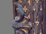 a tall wooden door with a decorative design on it