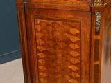 a wooden cabinet that has a marble top on top of it