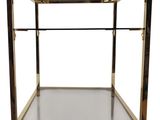 a brass and glass side table with a glass shelf