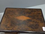 a small wooden box with a diamond design on it