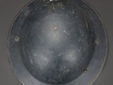 a metal helmet that is sitting on a table