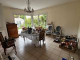 a room with a table, chairs, and a chandelier in it