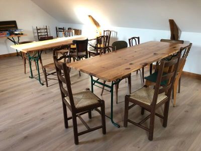 many chairs and tables in a room with a skylight