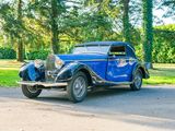 a blue vintage car parked on the side of the road