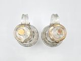 pair of silver and gold earrings on white background