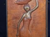an image of a bronze statue of a woman carrying a basket on her head