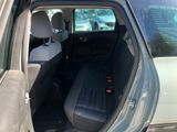 the back seat of a car with the door open in a parking lot