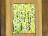 painting of a painting of a forest with yellow leaves in a wooden frame