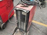two welding machines that are sitting in the parking lot